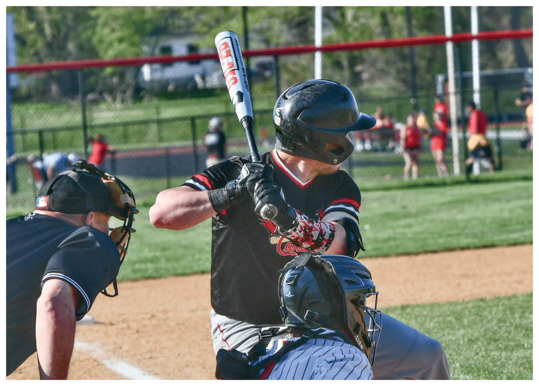 A baseball player is holding a bat and getting ready to swing. Description generated by AI