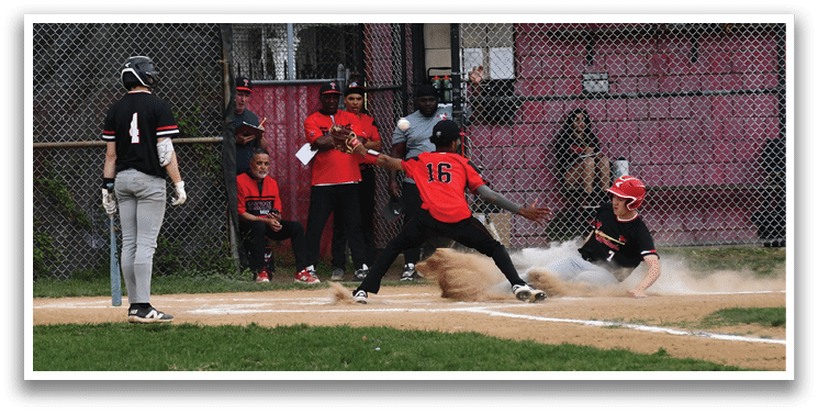 A baseball player slides into home plate. Description generated by AI
