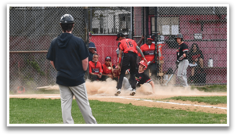 A baseball game is taking place with a player sliding into home base. Description generated by AI