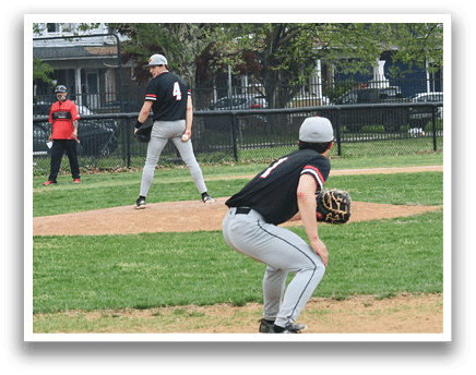 A baseball player is on the field wearing a black shirt and a white hat. Description generated by AI