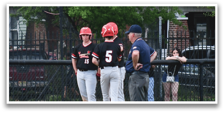 A baseball game is taking place with a group of people on the field. Description generated by AI