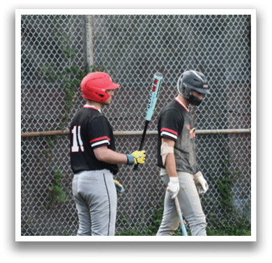 A baseball player wearing a red helmet and black shirt. Description generated by AI