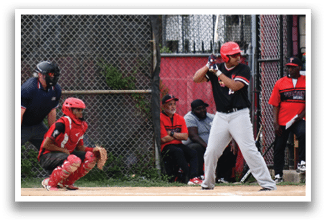 A baseball player is holding a bat and getting ready to swing. Description generated by AI
