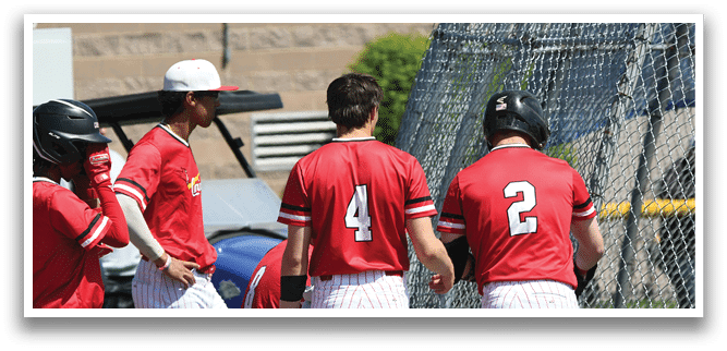 Baseball players wearing red and white uniforms. Description generated by AI