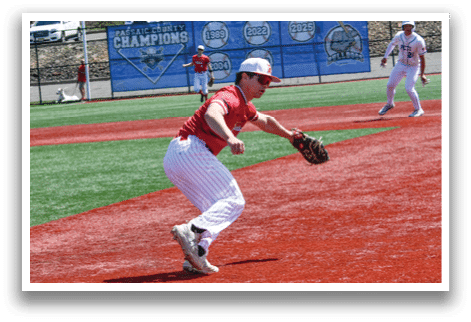 A baseball player in a red shirt and white pants is catching a ball. Description generated by AI