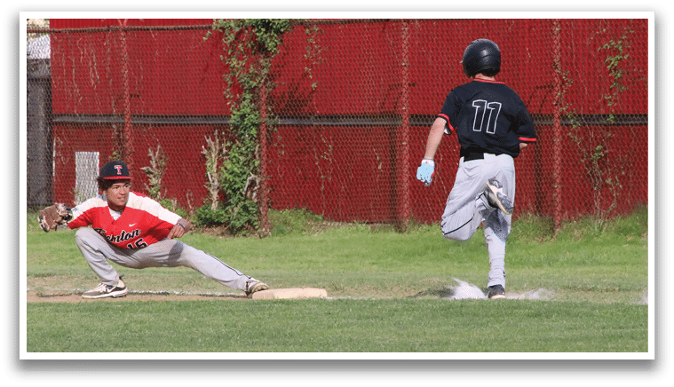 A baseball player sliding into a base. Description generated by AI