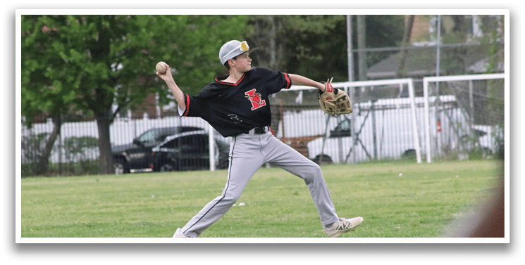 A boy in a black shirt and grey pants is throwing a baseball. Description generated by AI