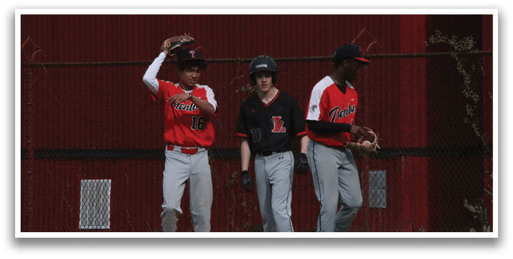 Three baseball players standing on a field. Description generated by AI