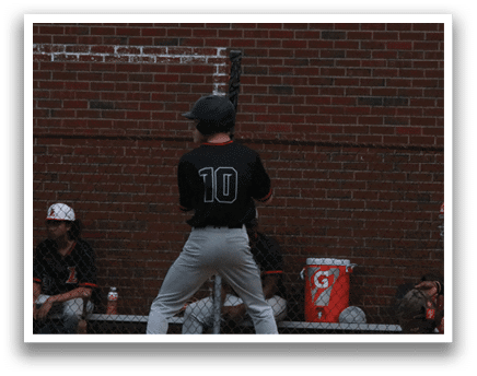 A baseball player wearing a black shirt and number 10. Description generated by AI