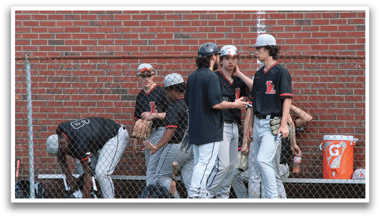 A group of baseball players wearing black and red uniforms. Description generated by AI