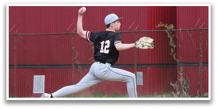 A baseball player in a black and red shirt and grey pants is in the process of throwing a ball. Description generated by AI