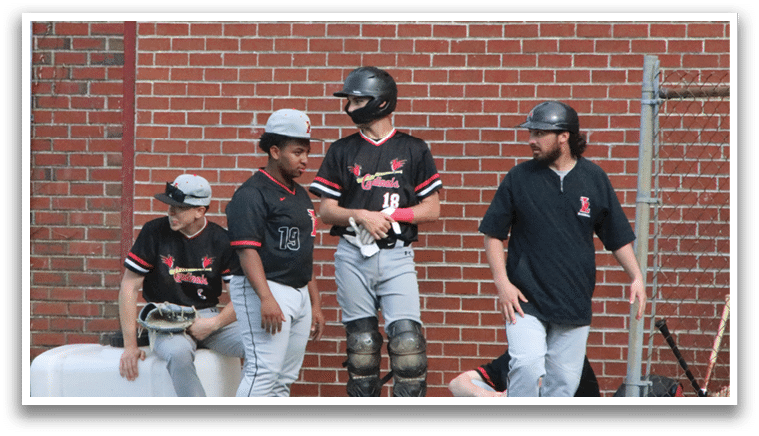 A group of baseball players standing on a field. Description generated by AI