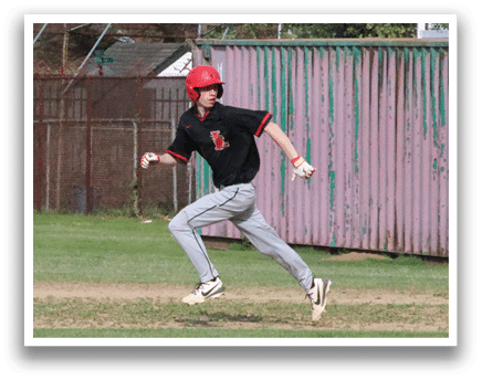 A baseball player in a black shirt and red hat is running towards a base. Description generated by AI