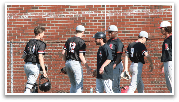 A group of baseball players wearing black shirts and white pants. Description generated by AI