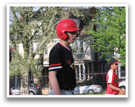 A boy wearing a red helmet and black shirt. Description generated by AI