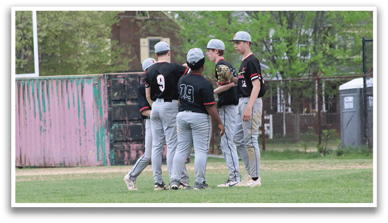 A group of baseball players wearing black and grey uniforms. Description generated by AI