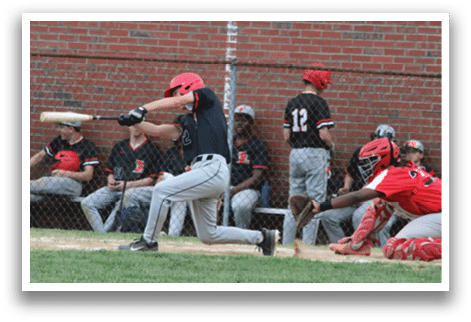 A baseball player in a black shirt and red helmet is swinging a bat. Description generated by AI