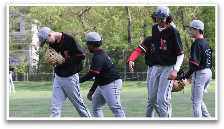 A group of young men wearing baseball uniforms. Description generated by AI