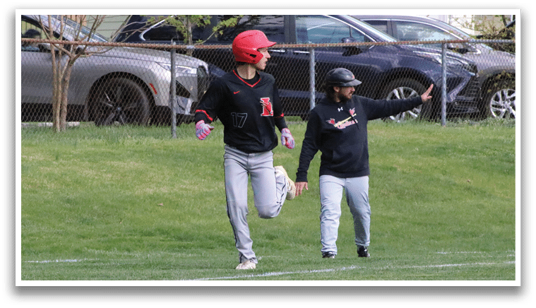Two men playing baseball in a field. Description generated by AI