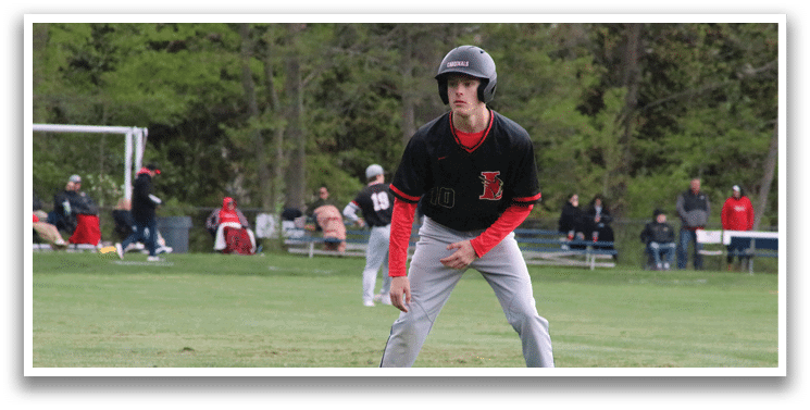 A baseball player wearing a black and red shirt and a helmet. Description generated by AI