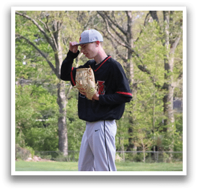 A man in a baseball uniform holding a catcher's mitt. Description generated by AI