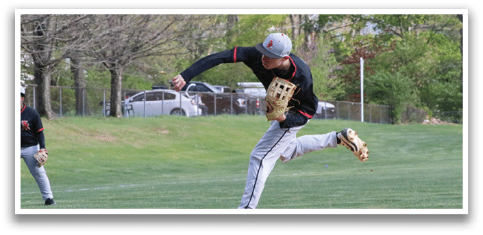 A baseball player in a black shirt and white pants is throwing a ball. Description generated by AI