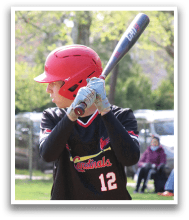 A baseball player in a black and red shirt holding a bat. Description generated by AI