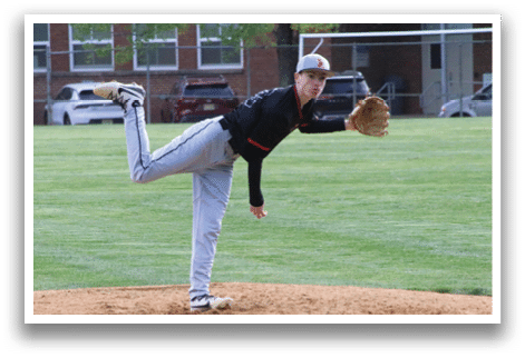 A baseball player in a black shirt and grey pants is pitching a ball. Description generated by AI