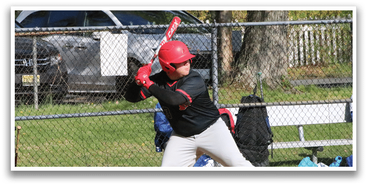 A baseball player in a red shirt and white pants is catching a ball. Description generated by AI