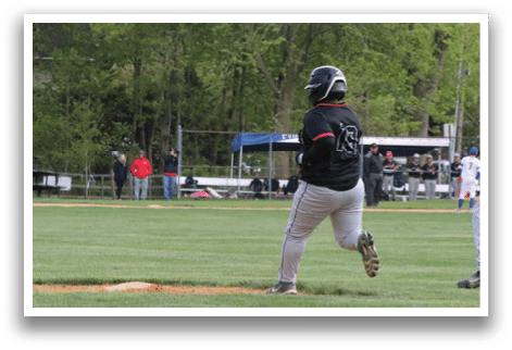 A baseball game is taking place with a player running to a base. Description generated by AI