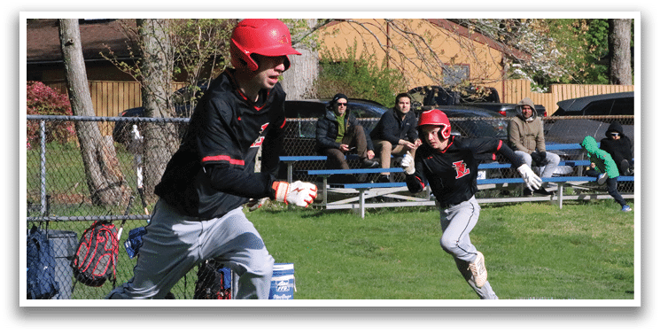 Two baseball players running on a field. Description generated by AI