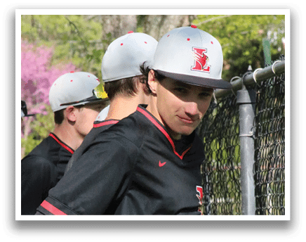 Two baseball players wearing black shirts and white hats. Description generated by AI