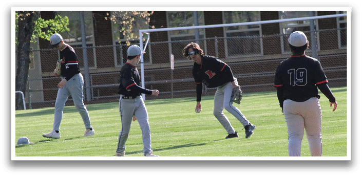 A group of people playing baseball on a field. Description generated by AI