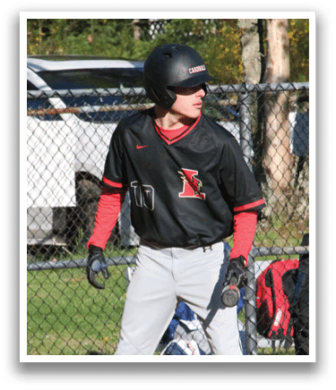 A baseball player wearing a black shirt and red sleeves. Description generated by AI