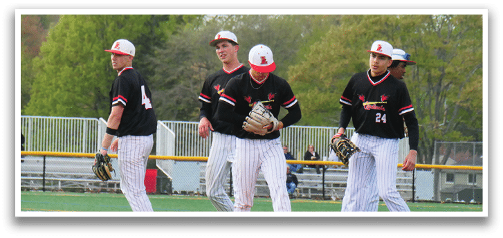 A group of baseball players standing on a field. Description generated by AI