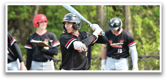 A baseball player holding a bat. Description generated by AI