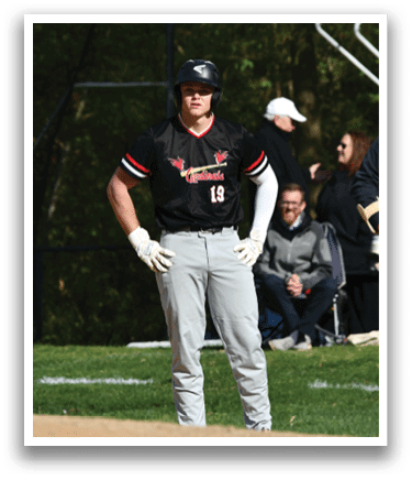 A baseball player wearing a black shirt with the number 19 on it. Description generated by AI