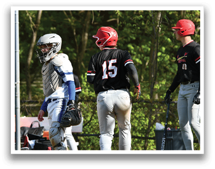 A baseball player wearing a black shirt with the number 15 on it. Description generated by AI