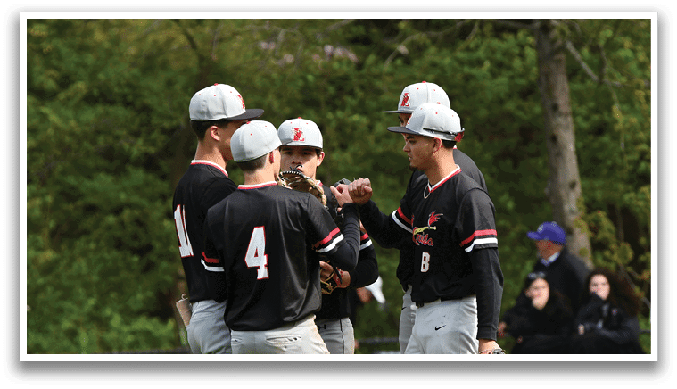 A group of baseball players wearing black and red uniforms. Description generated by AI