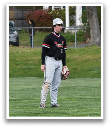 A baseball player wearing a black and red jersey and a white hat. Description generated by AI