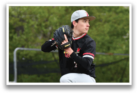 A baseball player in a black and red shirt and grey pants is pitching a ball. Description generated by AI