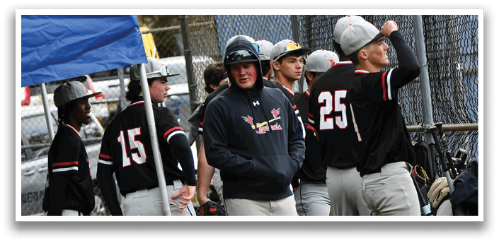 Baseball players standing in front of a fence. Description generated by AI