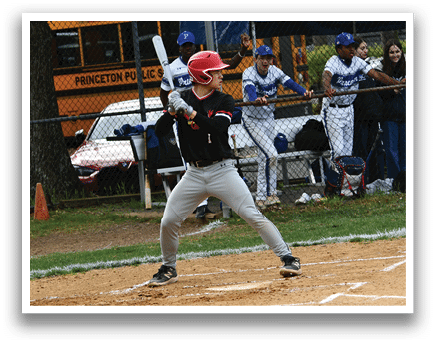 A baseball player in a black shirt and red helmet is swinging a bat. Description generated by AI