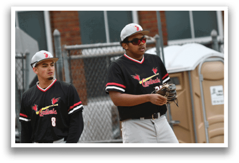 Two men wearing baseball uniforms. Description generated by AI