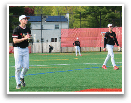A baseball field with two players standing on it. Description generated by AI