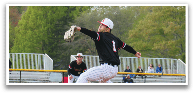 A baseball player in a black shirt and white hat is pitching a ball. Description generated by AI