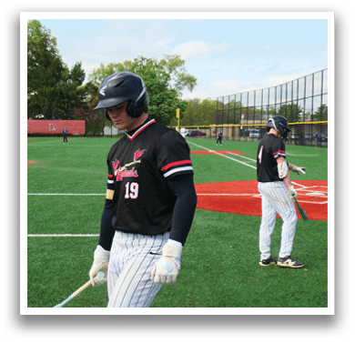 A baseball player holding a bat. Description generated by AI