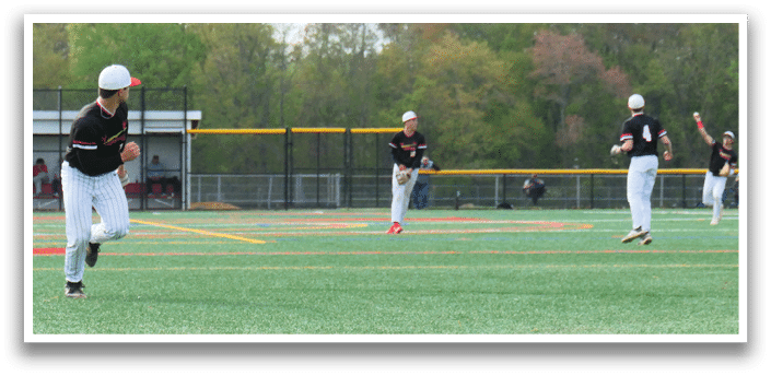 A baseball player is running to a base. Description generated by AI