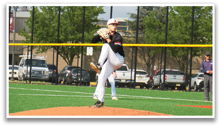 A baseball player in a black shirt and white pants is pitching a ball. Description generated by AI
