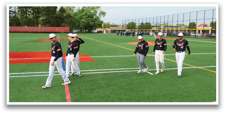 A group of baseball players walking on a field. Description generated by AI
